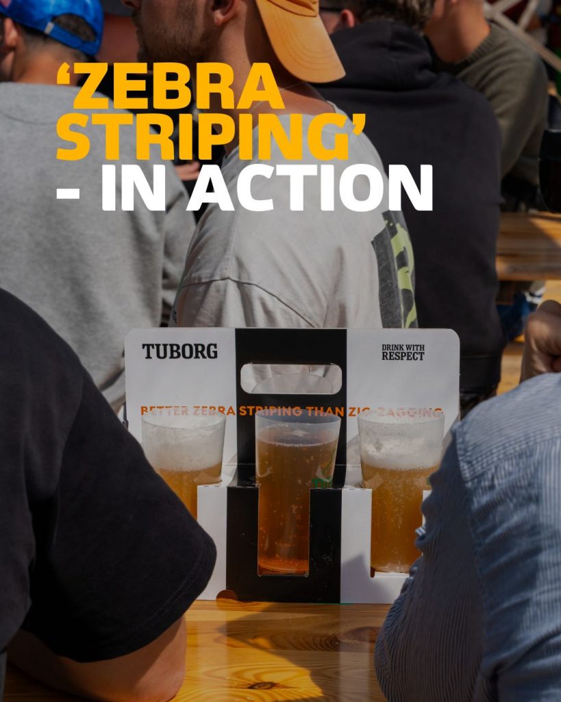 3 glasses of Tuborg beer in a display that reads "Tuborg | Drink with respect | Better zebra striping than zig zagging". On screen text in yellow and white reading " 'zebra striping' in action".