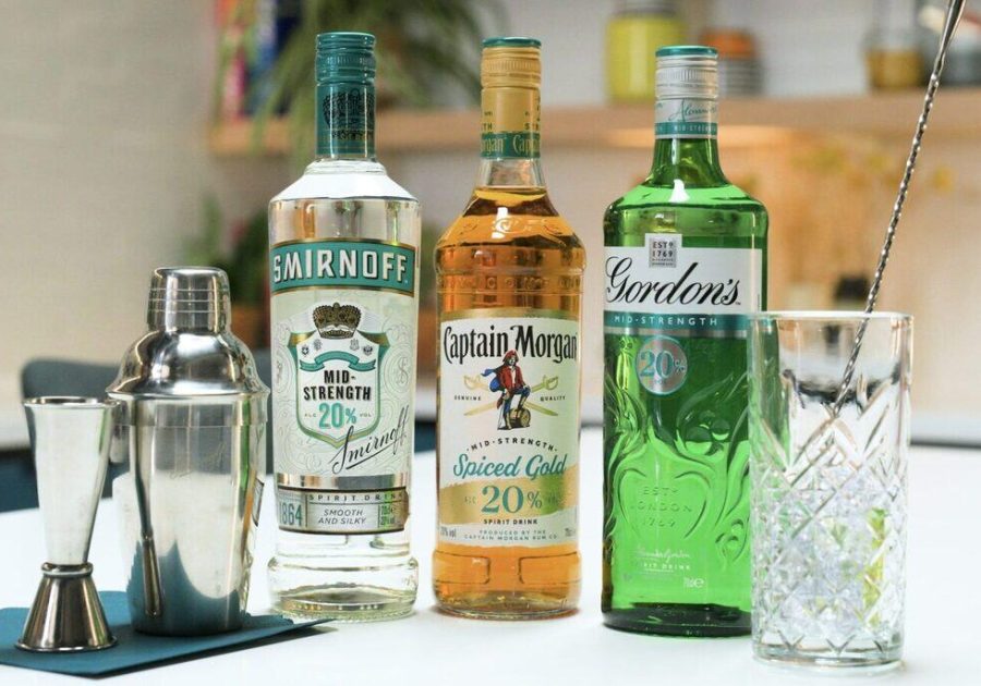 3 bottles of Smirnoff, Captain Morgan's and Gordon's labelled 'mid-strength 20%'